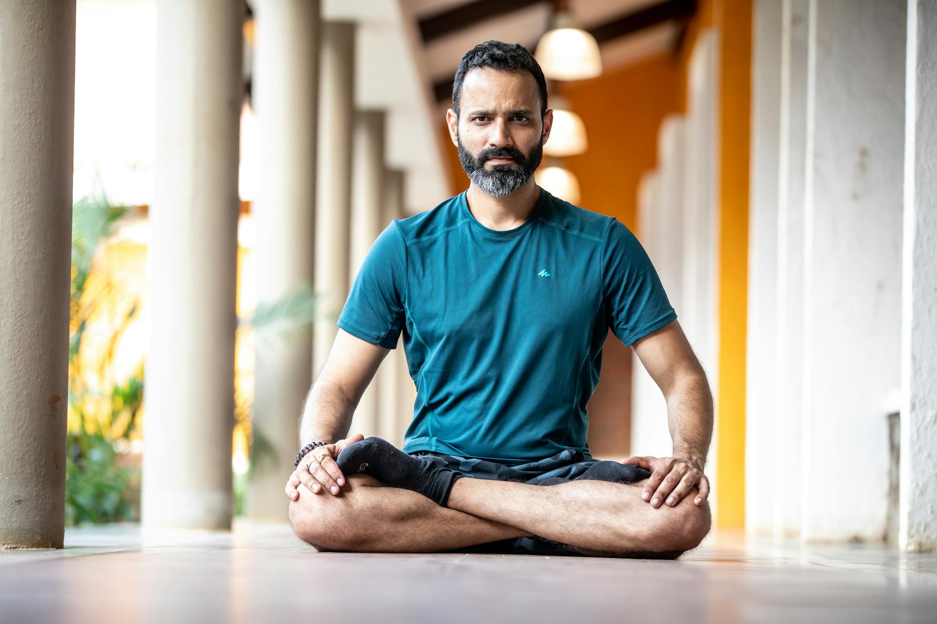 man meditating indoors in peaceful setting